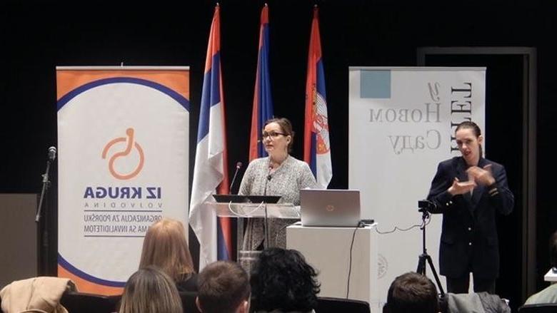 A woman giving a presentation at a podium