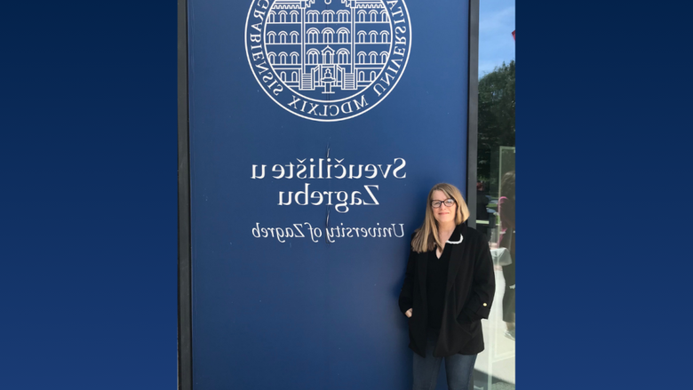 a person standing in front of a banner 