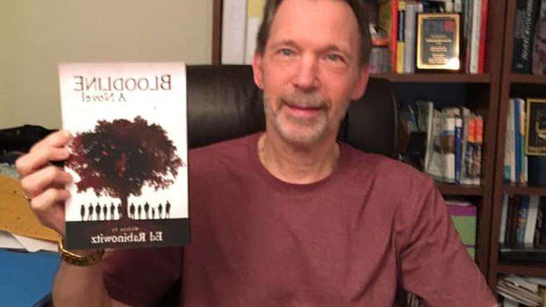 Ed Rabinowitz holds a copy of "Bloodline"